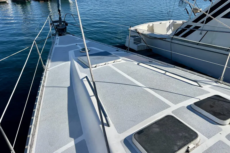 Slide: The Image of 1986 Hunter Legend 45 sailboat deck with hatches, docked on calm water. - 12