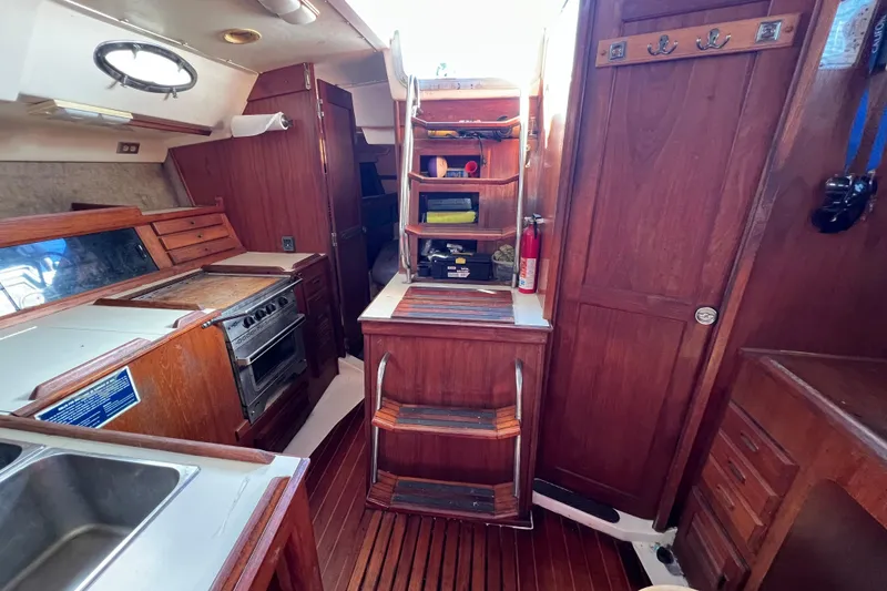 Slide: The Image of Interior of 1986 Hunter Legend 45 sailboat with wooden cabinetry and kitchen area. - 25