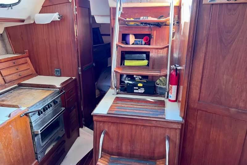 Slide: The Image of Interior of 1986 Hunter Legend 45 sailboat with wooden cabinetry and kitchen area. - 26