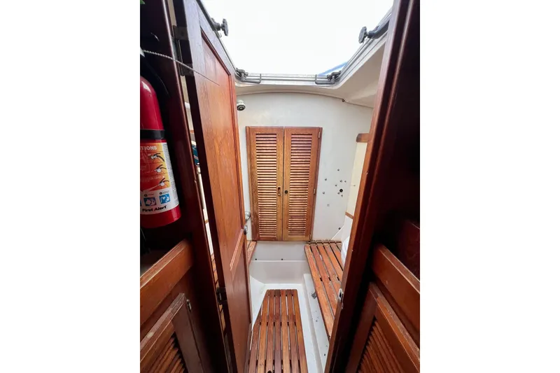Slide: The Image of Interior of 1986 Hunter Legend 45 sailboat with wooden finishes and fire extinguisher. - 35