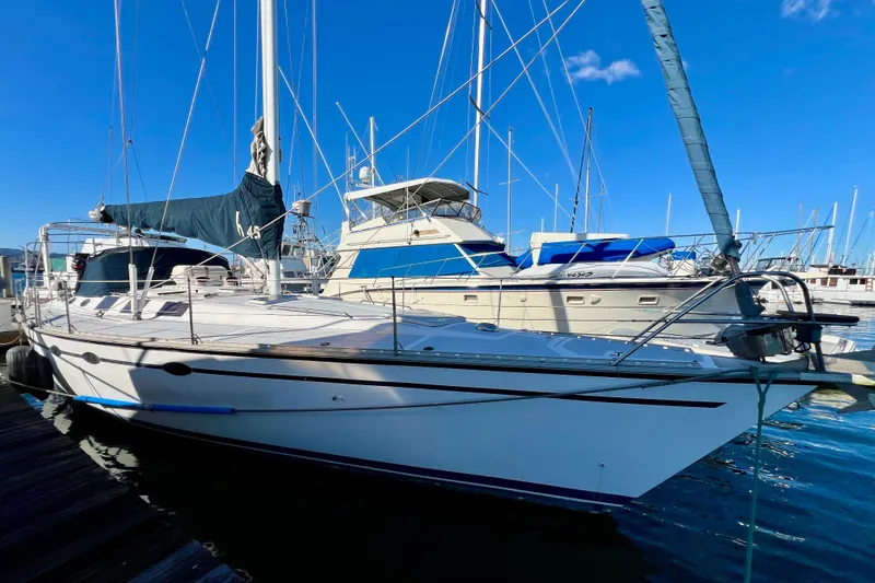 Slide: The Image of 1986 Hunter Legend 45 sailboat docked at marina under clear blue sky. - 8