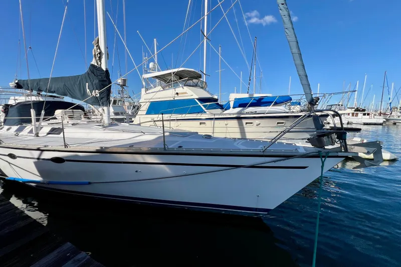 Slide: The Image of 1986 Hunter Legend 45 sailboat docked in a marina under clear blue skies. - 9