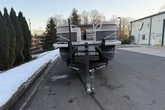 Slide: The Image of 2017 Sun Tracker Party Barge 20 DLX pontoon boat on trailer, parked on a street. - 3