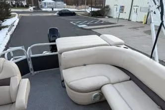 Slide: The Image of 2017 Sun Tracker Party Barge 20 DLX with beige seating in a parking lot. - 5