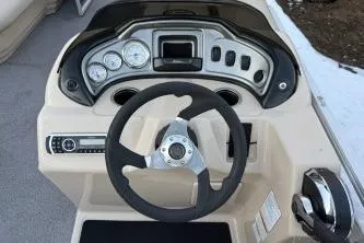 Slide: The Image of 2017 Sun Tracker Party Barge 20 DLX dashboard with steering wheel and gauges. - 7