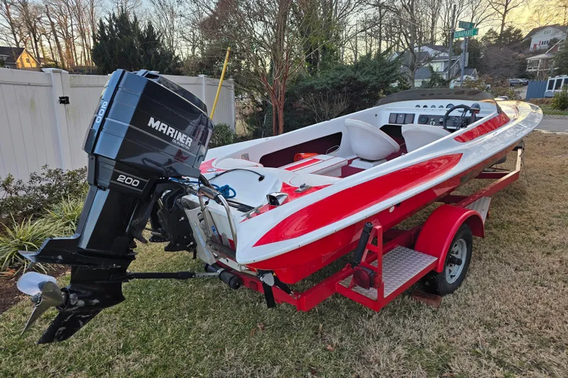 Slide: The Image of 1978 Allison Boats 20 with Mariner 200 engine on red trailer, parked outdoors. - 0