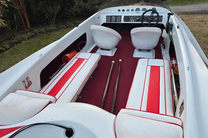 Slide: The Image of 1978 Allison Boats 20 interior with red and white seating, steering wheel, and dashboard. - 1