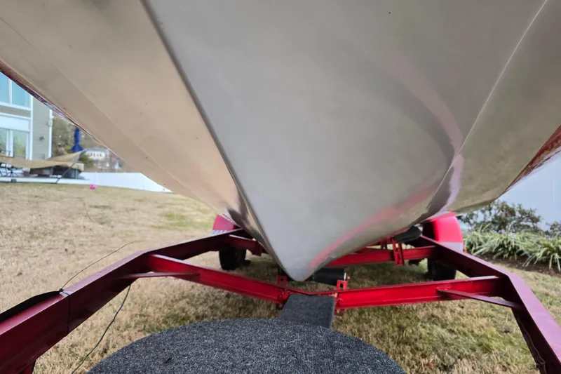 Slide: The Image of 1978 Allison Boats 20 on red trailer, viewed from below, parked on grass. - 10