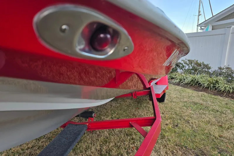 Slide: The Image of 1978 Allison Boats 20 on red trailer, close-up view, parked on grass. - 11