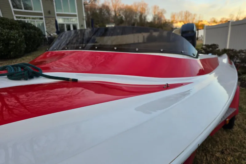 Slide: The Image of 1978 Allison Boats 20, red and white speedboat, parked outdoors near a house. - 12
