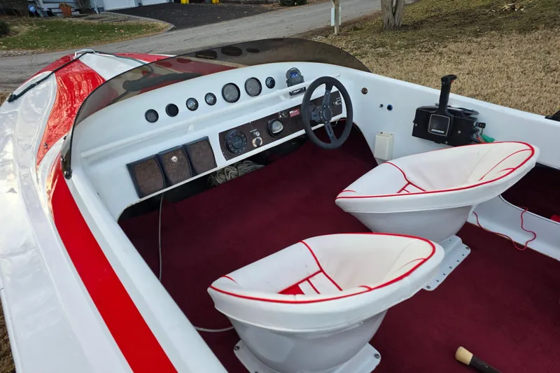 Slide: The Image of 1978 Allison Boats 20 interior with red accents and dual white seats. - 15