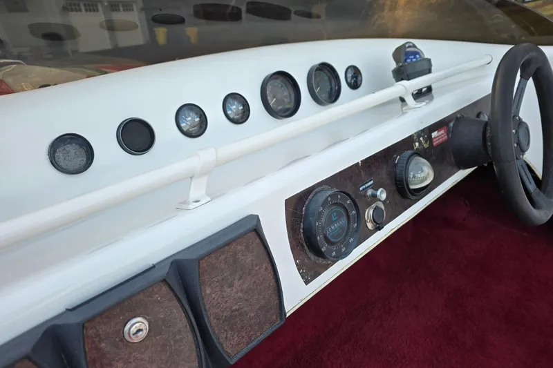 Slide: The Image of 1978 Allison Boats 20 dashboard with gauges and steering wheel, featuring vintage design elements. - 16