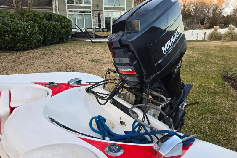 Slide: The Image of 1978 Allison Boats 20 with Mariner outboard motor, parked on grass near a house. - 17