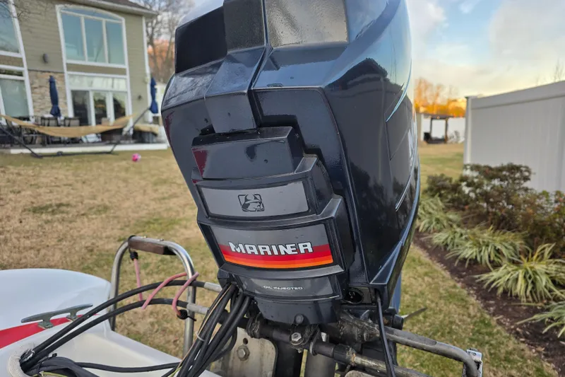 Slide: The Image of 1978 Allison Boats 20 with Mariner outboard motor in a backyard setting. - 18