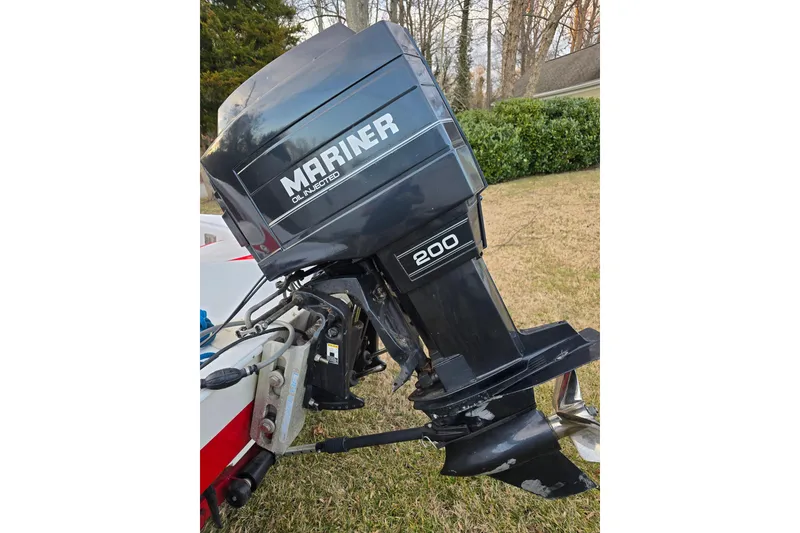 Slide: The Image of 1978 Allison Boats 20 with Mariner 200 outboard motor, oil-injected, on grassy background. - 19