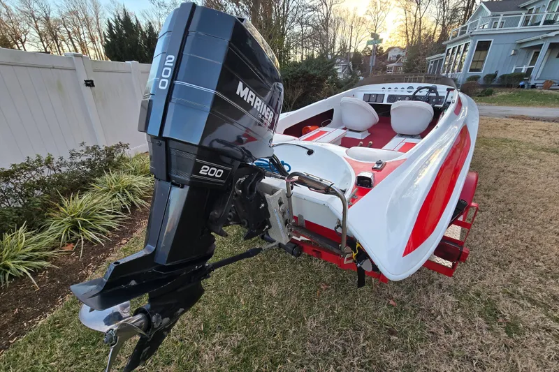 Slide: The Image of 1978 Allison Boats 20 with Mariner 200 outboard motor, parked on grass. - 20