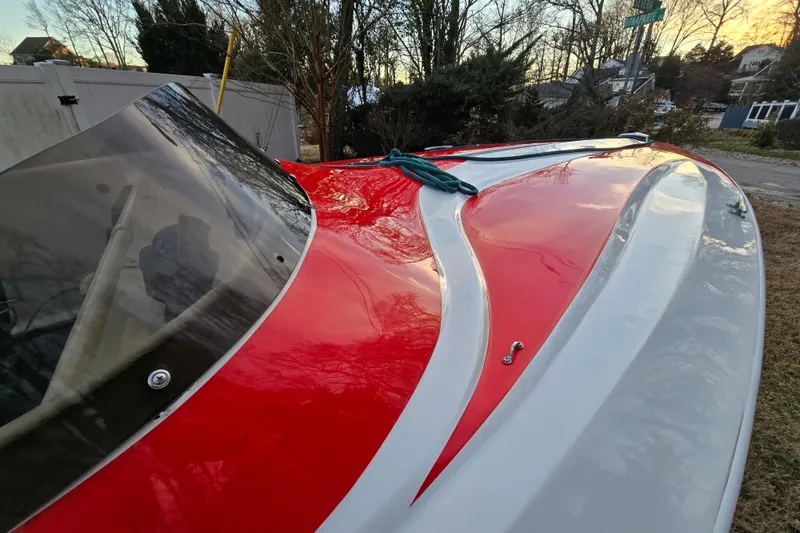 Slide: The Image of 1978 Allison Boats 20 with red and white design, parked outdoors. - 26