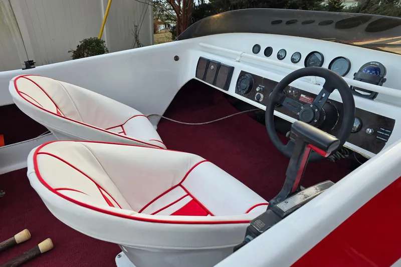 Slide: The Image of 1978 Allison Boats 20 interior with red and white seats, steering wheel, and dashboard controls. - 3