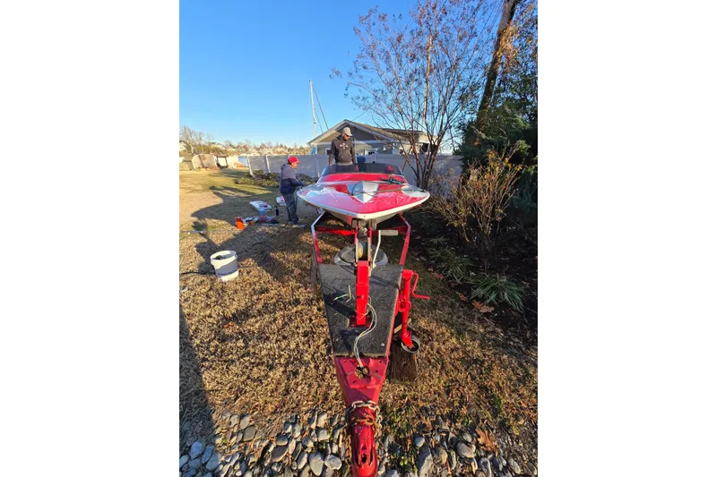 Slide: The Image of 1978 Allison Boats 20 on trailer, outdoor setting, people working nearby. - 4