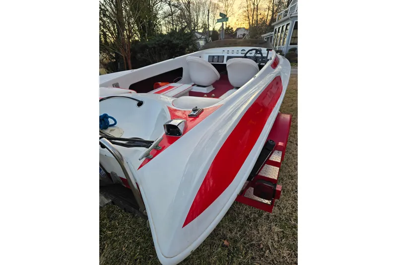 Slide: The Image of 1978 Allison Boats 20, red and white speedboat, parked on grass. - 5