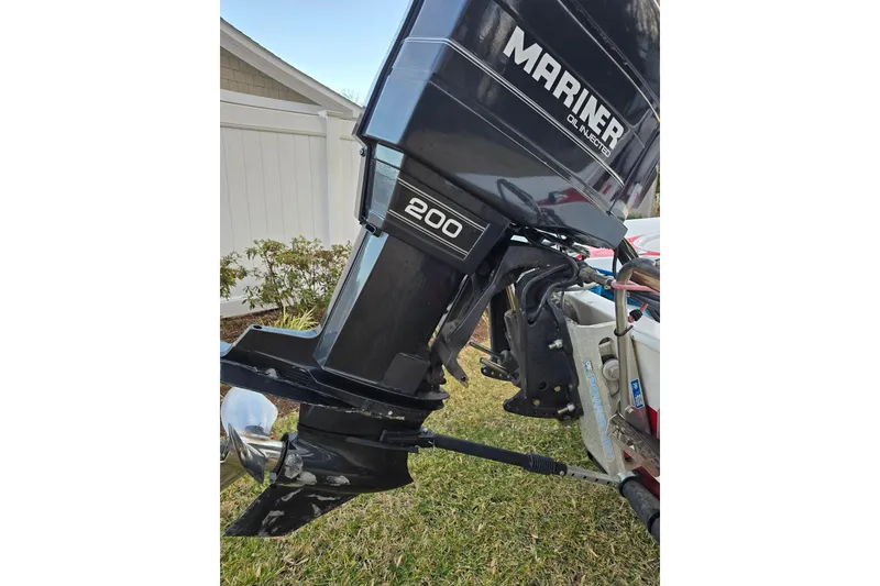 Slide: The Image of 1978 Allison Boats 20 with Mariner 200 outboard motor, parked on grass. - 6