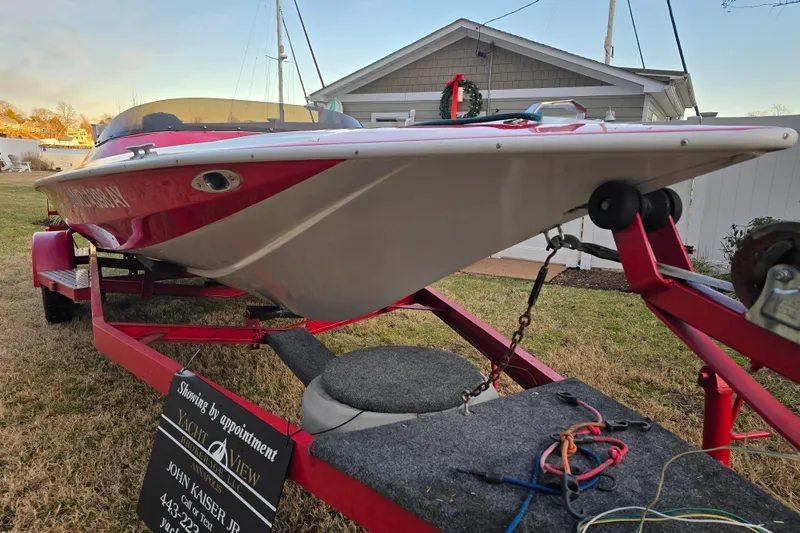Slide: The Image of 1978 Allison Boats 20 on trailer, red and white, parked in front of a house. - 8