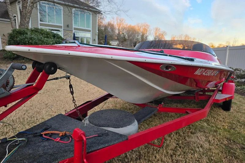 Slide: The Image of Red 1978 Allison Boats 20 on trailer, parked in front of a house. - 9