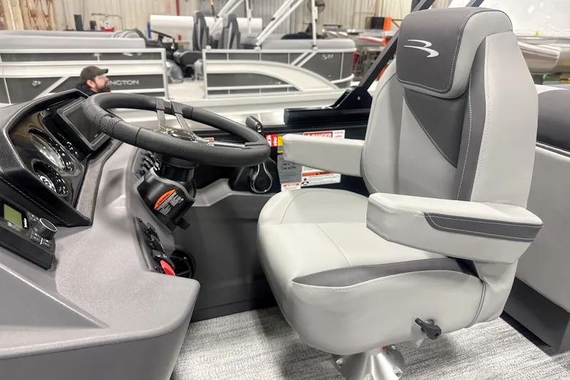 Slide: The Image of 2026 Bennington 22 S STERN RADIUS boat interior with steering wheel and captain's chair. - 12