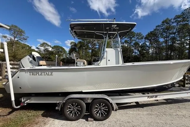The Image of 2017 Stuart 27 boat on trailer under blue sky. - 0
