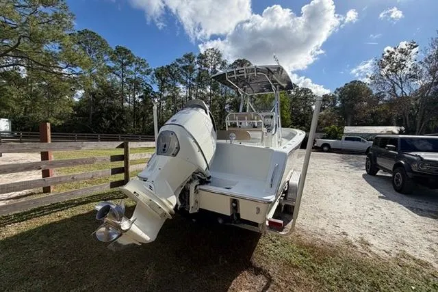 Slide: The Image of 2017 Stuart 27 boat with outboard motor in a sunny outdoor setting. - 16