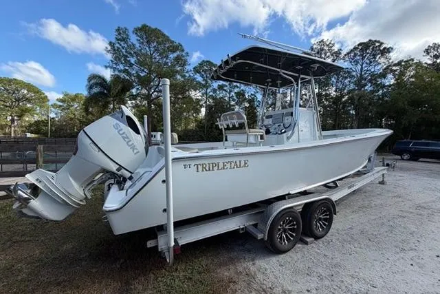 Slide: The Image of 2017 Stuart 27 boat on trailer with Suzuki engine, parked outdoors. - 5