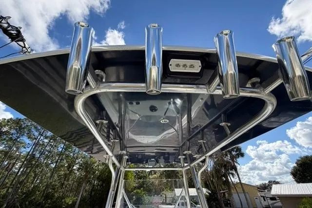 Slide: The Image of 2017 Stuart 27 boat with stainless steel rod holders under a clear blue sky. - 9
