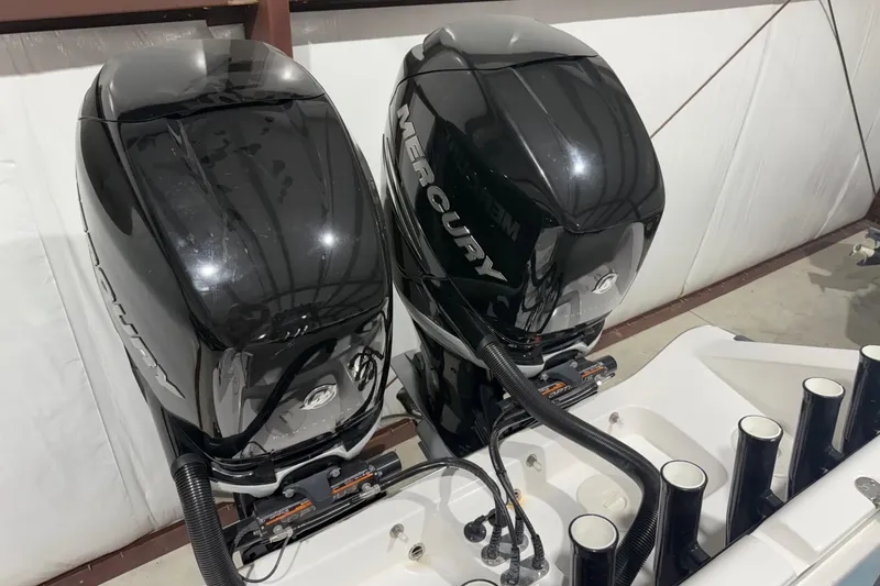Slide: The Image of 2023 Cape Horn 34 XS boat with dual Mercury outboard engines in a storage facility. - 14