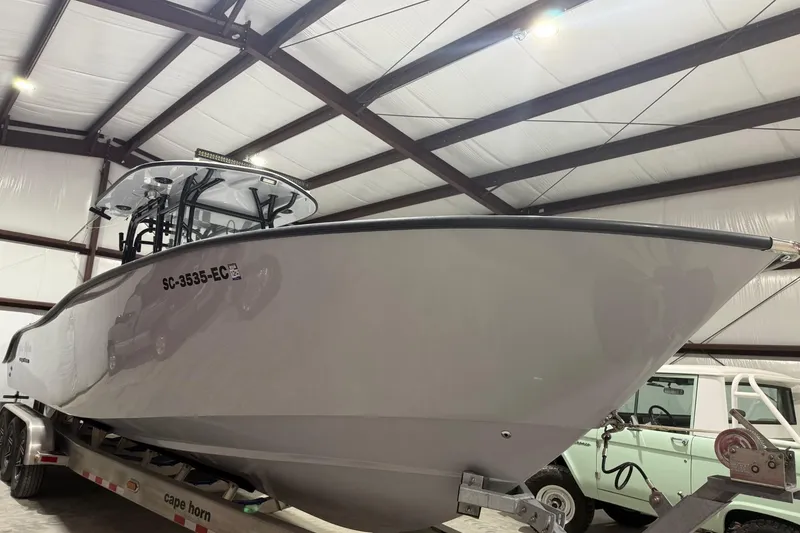 Slide: The Image of 2023 Cape Horn 34 XS boat on trailer in a storage facility. - 17