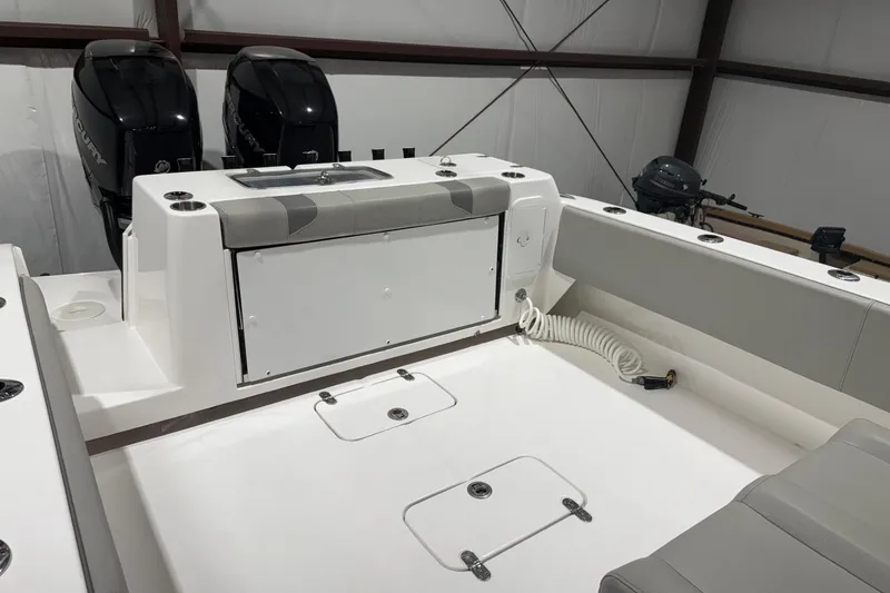 Slide: The Image of 2023 Cape Horn 34 XS boat interior with dual Mercury engines in a storage facility. - 21