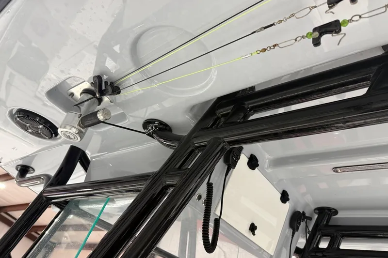 Slide: The Image of 2023 Cape Horn 34 XS boat interior with fishing rod holders and black framework. - 23