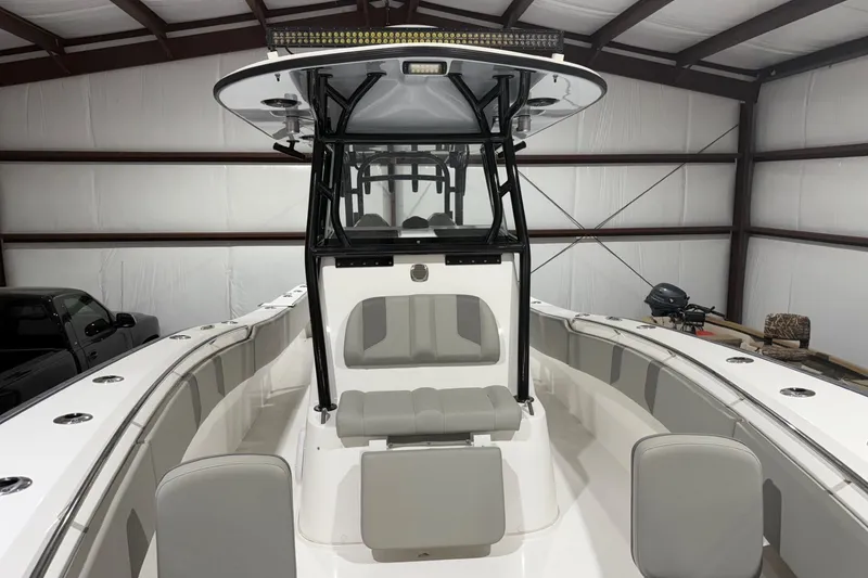 Slide: The Image of 2023 Cape Horn 34 XS boat interior with seating and console in a storage facility. - 27