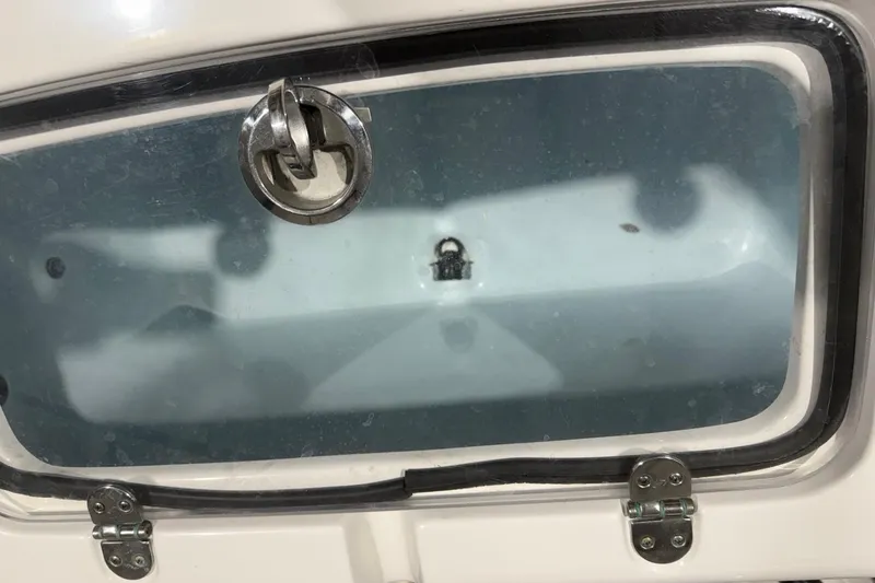 Slide: The Image of 2023 Cape Horn 34 XS boat compartment with metal latch and clear window. - 31