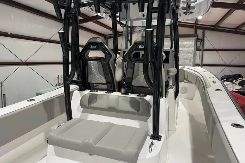 Slide: The Image of 2023 Cape Horn 34 XS boat interior with seating and console in a storage facility. - 33