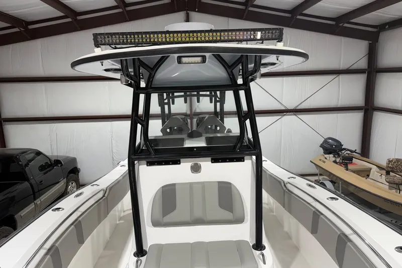 Slide: The Image of 2023 Cape Horn 34 XS boat interior with T-top and seating in a garage. - 12