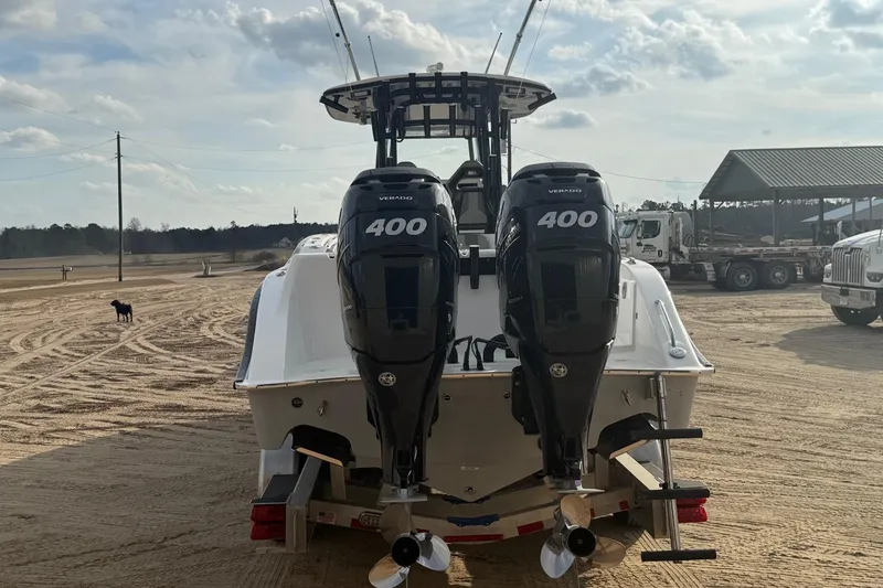 Slide: The Image of 2023 Cape Horn 34 XS boat with dual 400 Verado engines on a sandy lot. - 36