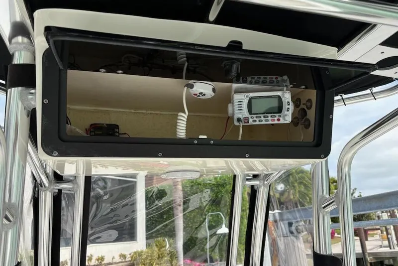 Slide: The Image of 2023 Key West 210 Bay Reef boat console with electronic equipment and storage compartment. - 11