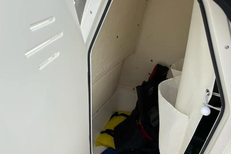 Slide: The Image of Storage compartment of 2023 Key West 210 Bay Reef boat with life jackets. - 17