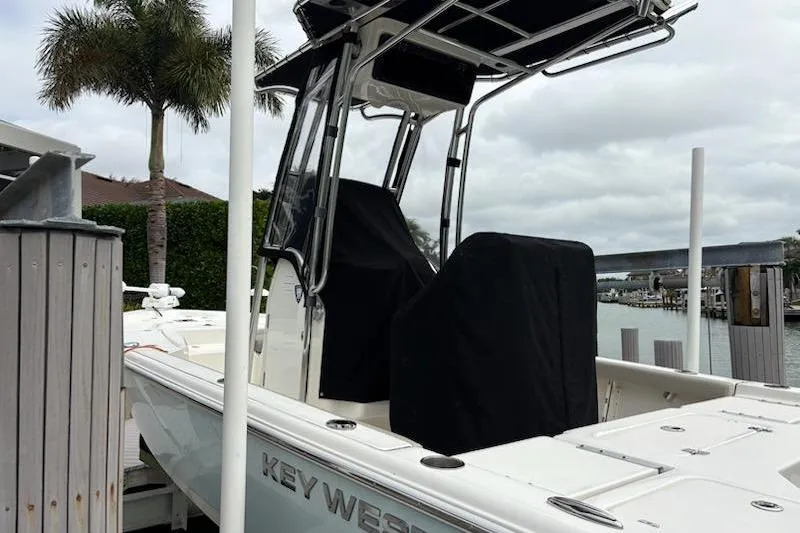 Slide: The Image of 2023 Key West 210 Bay Reef boat docked near palm trees and waterway. - 19