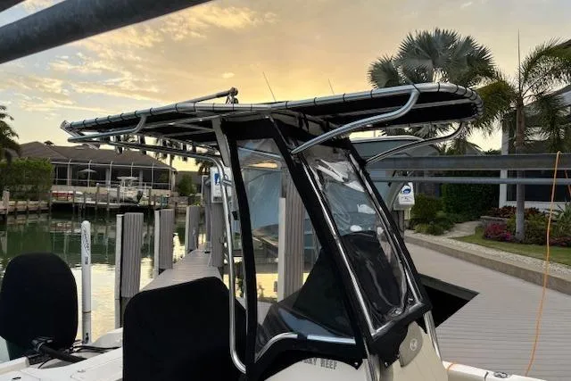 Slide: The Image of 2023 Key West 210 Bay Reef boat docked at sunset with palm trees. - 26