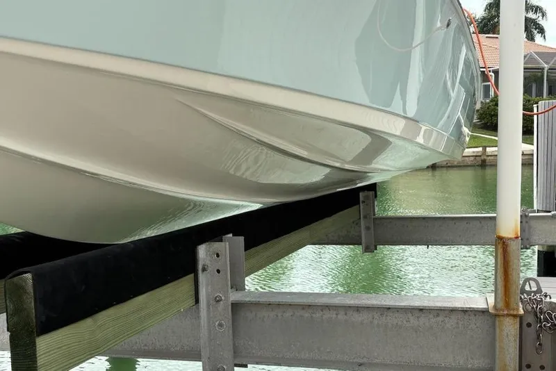 Slide: The Image of 2023 Key West 210 Bay Reef boat on lift by waterfront. - 4