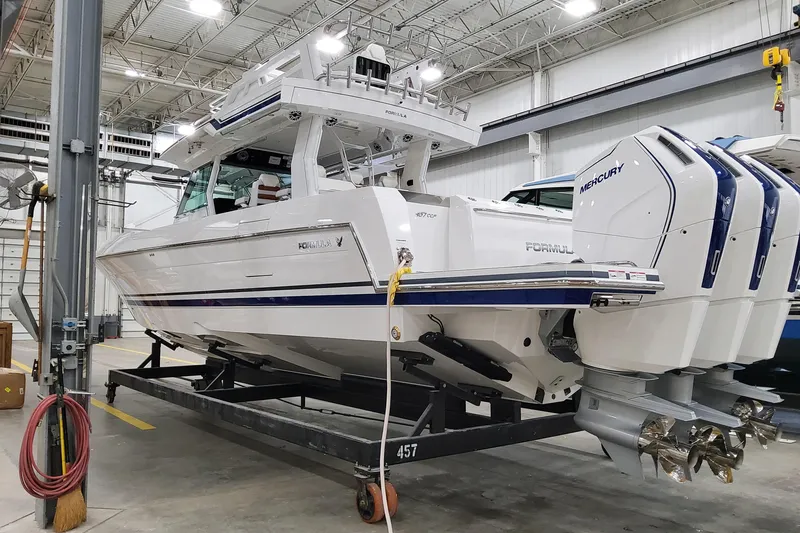 The Image of 2026 Formula 457 Center Console Fish boat in a warehouse, featuring triple Mercury engines. - 1