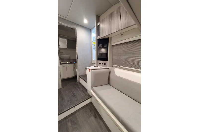 Slide: The Image of Interior of 2026 Formula 457 Center Console Fish boat, featuring modern seating and cabinetry. - 11