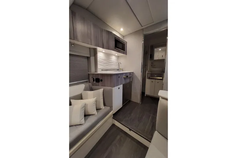 Slide: The Image of Interior of 2026 Formula 457 Center Console Fish boat with modern kitchen and seating area. - 12