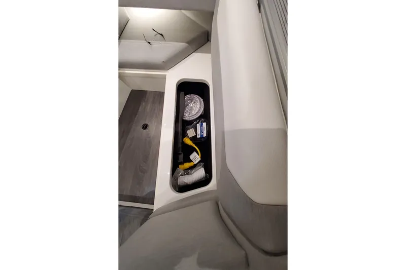 Slide: The Image of 2026 Formula 457 Center Console Fish storage compartment with cables and equipment. - 18